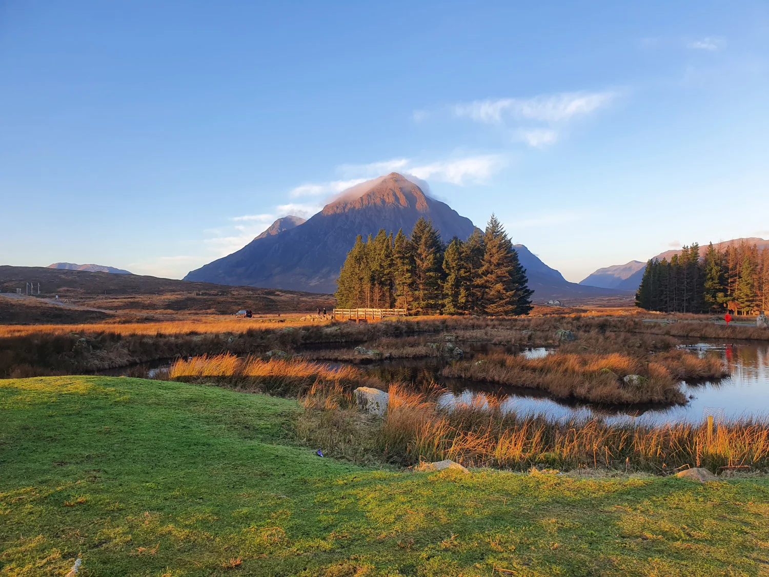 Buachaille Etive Mòr's pyramid peak seen across open moorland from Kingshouse under a clear blue sky