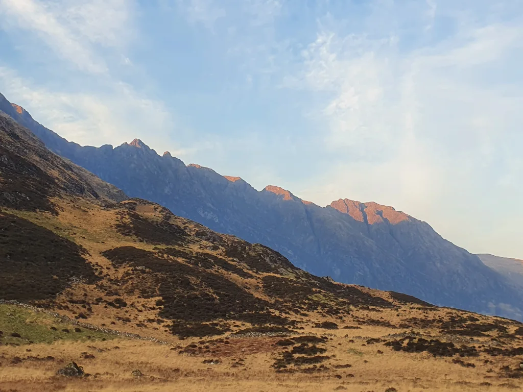 Sunlight catches the Aonach Eagach ridge in Glencoe showing its steep, rocky profile in all its detail